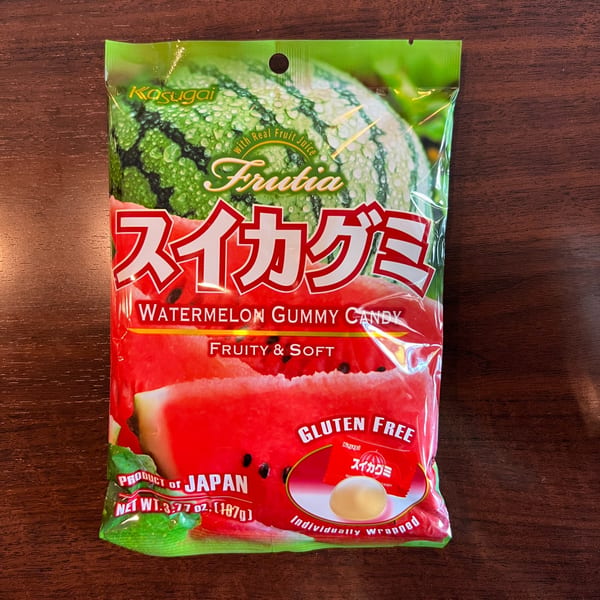 A green and red bag of Kasugai Frutia Watermelon Gummy Candy, featuring watermelon imagery.